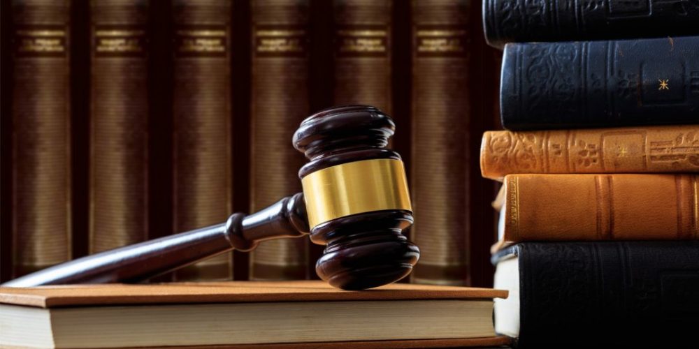 judge-gavel-on-a-book-law-books-background-wooden-desk-e1622361337922.jpg