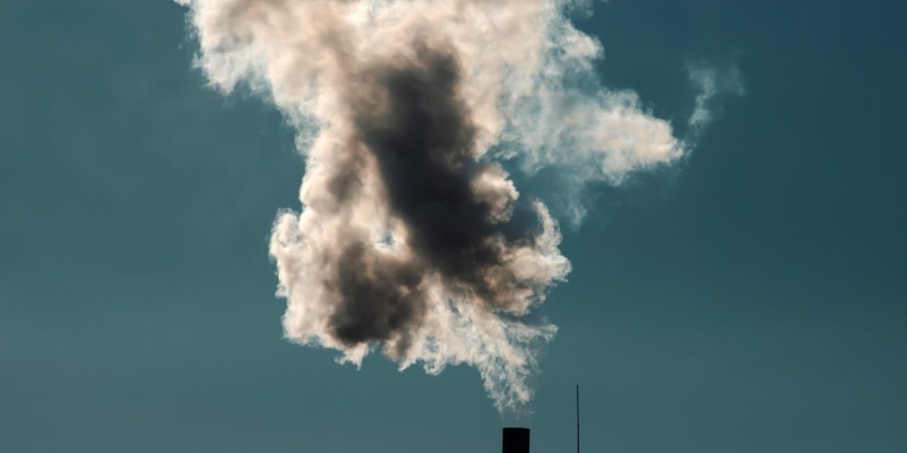 Air pollution from power plant chimneys. Industry and global warming concept